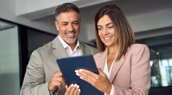two people reading a tablet