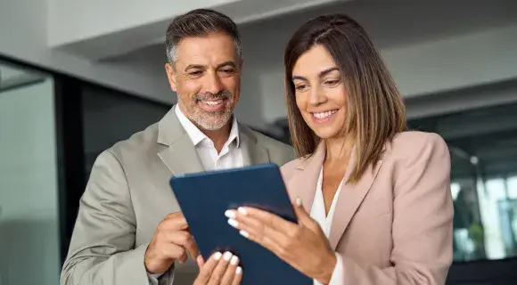 two people reading a tablet